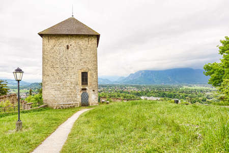 Panoramic view over stadt salzburg with ancient tower, rainy day and mountains, austriaの写真素材