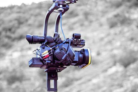 Tv camera recording on a crane, isolated on black and white background