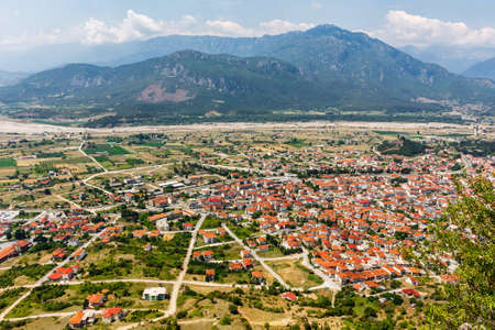 Aerial sunset view at old city village, fields and green mountains in Greece, Corfuの写真素材