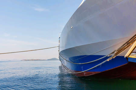 Agia Triada cargo ship on coast of port at sunset in Greece, Corfuの写真素材