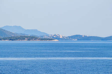 View from sea to Corfu island part and town. Greece, sunset.