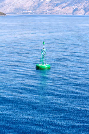 Green buoy floating in sea. Corfu island, Greeceの写真素材