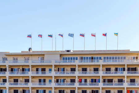 Different countries flags on hotel building. Corfu island, Greece. Daylightの写真素材