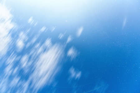 Blue sky at night with stars and white clouds, long exposureの写真素材