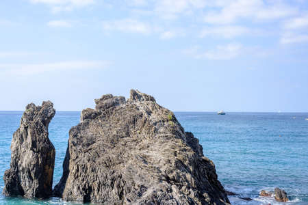 Daylight view to water splashing rock and blue sea. Monterosso al Mare, Italy, Cinque Terreの写真素材