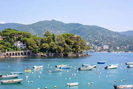 Daylight view to boats on water and city of Rapallo, Italy.の写真素材