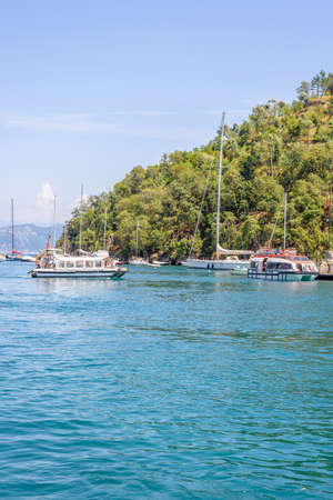 Daylight view to ships cruising on water near Portofino city in Italyの写真素材