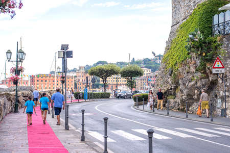 SANTA MARGHERITA LIGURE, ITALY - JUNE 27, 2017: Beautiful daylight view to Santa Margherita Ligure city road in Italy. People walking on sidewalk. Mountains and blue sky background.のeditorial素材