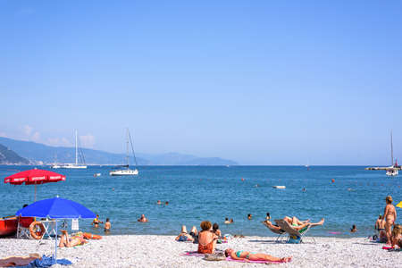 SANTA MARGHERITA LIGURE, ITALY - JUNE 26, 2017: Beautiful sunny day on Santa Margherita Ligure beach in Italy. Tourists and people relaxing and swimming in waterのeditorial素材