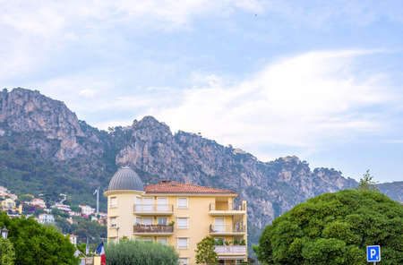 Daylight view to a hotel and big mountains in Beaulieu sur mer, Franceの写真素材
