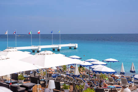NICE COTE D'AZUR, FRANCE - JUNE 27,2017: Beautiful daylight view to beach resort with flags of Europe on bay.のeditorial素材
