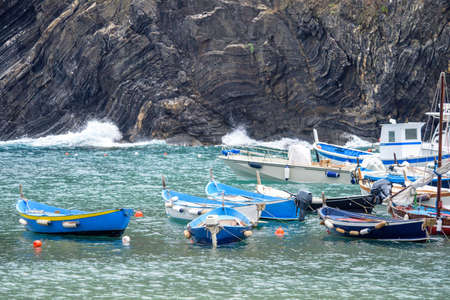 Daylight view to parked boats near rock mountains. Vernazza, Cinque Terre, Italyの写真素材