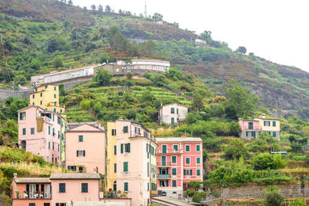 View to city buildings and mountains in a foggy day. Vernazza, Cinque Terre, Italy