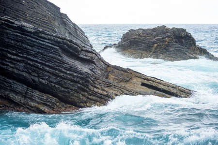 Water smashing big rocks in Vernazza, Cinque Terre, Italyの写真素材