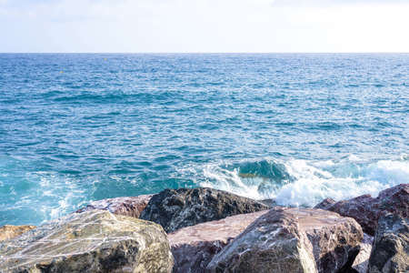 Water splashing on rocks at coastline in Monterosso al Mare, Italy