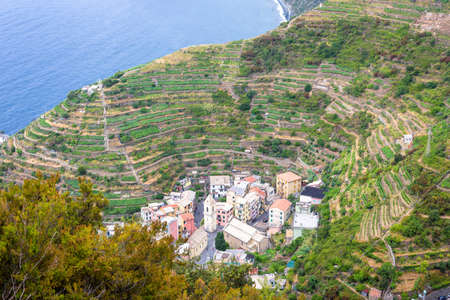Aerial view from mountains to road with cars parked. Manarola, Italy