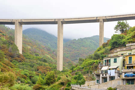 Tall railway in mountains and above city. Riomaggiore, Italyの写真素材