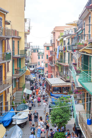 MANAROLA, ITALY - JUNE 25, 2017: Beautiful view to city architecture and street with people walking and relaxingのeditorial素材