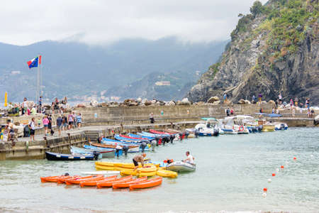 VERNAZZA, ITALY - JUNE 26, 2017: View to little port of city with parked boats and people walkingのeditorial素材
