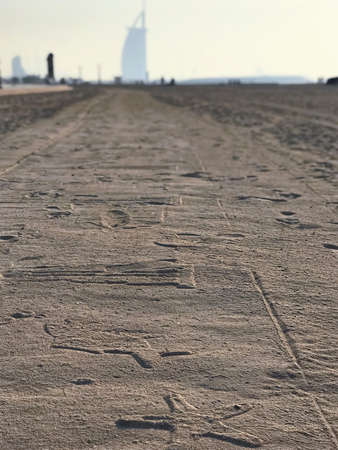 Suset view to ornamented sand road with stars. Burj Al Arab building on background. Dubai, United Arab Emiratesの写真素材