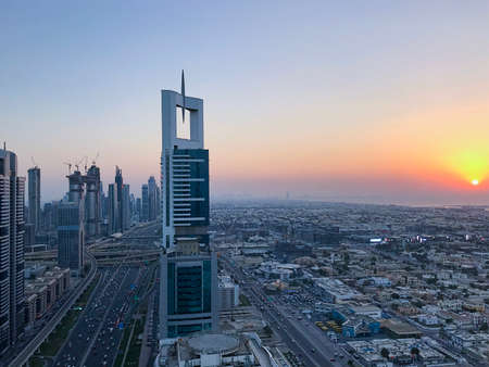 Beautiful aerial view with purple sky from top to sunrise and city futuristic skylines buildings and infrastructure. Dubai, United Arab Emiratesのeditorial素材
