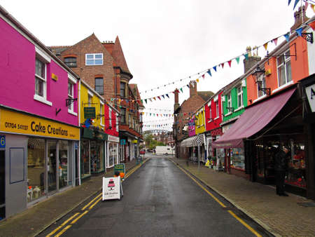 SOUTHPORT, UNITED KINGDOM - OCTOBER 21, 2017: City street with shops and colored buildings on a rainy dayのeditorial素材