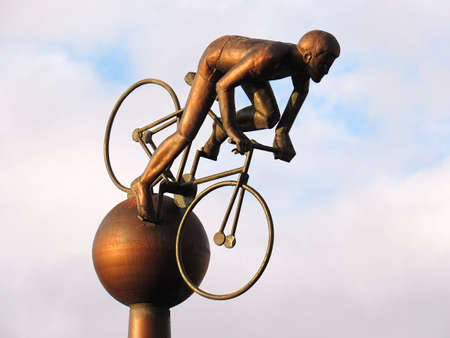 SOUTHPORT, UNITED KINGDOM - OCTOBER 23, 2017: Metalic statue of a sportmen riding a bike over blue skyのeditorial素材
