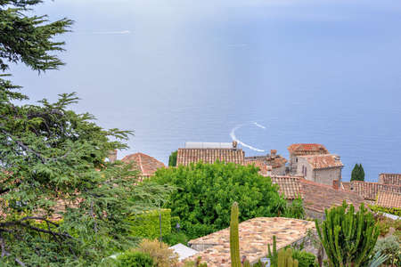 Daylight foggy view to Eze village with botanical garden full of cactuses. Beauties of French...