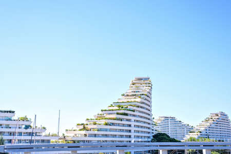 Daylight sunny view from side to ship shaped apartments. Bright blue clear sky on background. View...