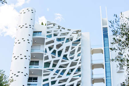 MONTE CARLO, MONACO - JUNE 29, 2017: Daylight view from bottom to latticed facade of Simona Tower Block by Jean-Pierre Lott. Luxury apartments in skyscraper. Negative copy space, place for textのeditorial素材