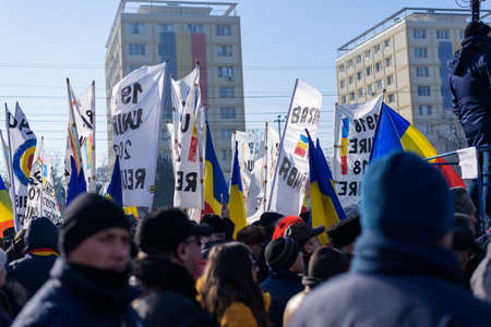 IASI, ROMANIA - JANUARY 24, 2018: People with placards marching and celebrating on the main street at the national day of 100 years since unification of Romania, tricolor flagのeditorial素材
