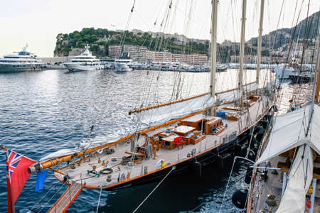 Moored old ship in Monaco, yachts and buildings on the backgroundの写真素材