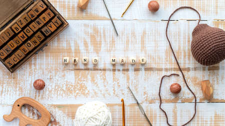 Working with yarn, wooden set of letters, hand made things, materials and instruments composition. Top viewの写真素材