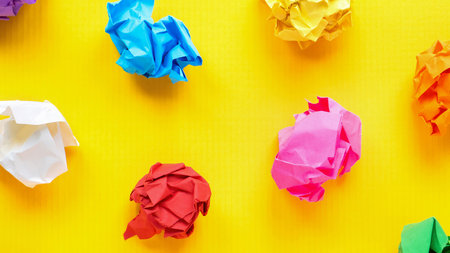 Colored smashed papers on yellow background