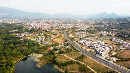 Aerial drone view of Tirana, Albania. Residential district with buildings and greenery. Mountains in the distanceの写真素材