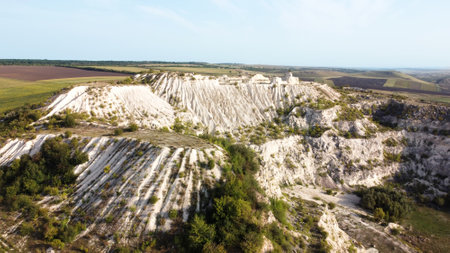 Aerial drone view of nature in Moldova. Abandoned quarry with white slopes, fields in the distanceの写真素材