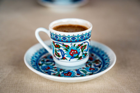 Close view of coffee in a traditional turkish cup on a dishの写真素材