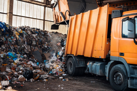 An garbage truck unloading garbage at waste sorting plantの写真素材