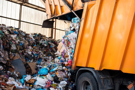 An garbage truck unloading garbage at waste sorting plantの写真素材