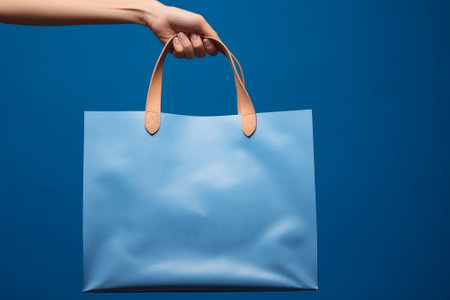 A shopping bag on a blue backgroundの素材