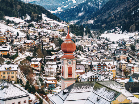 Aerial drone view of the Ortisei town covered in snow, within the Dolomites, in northern Italyの写真素材