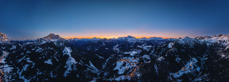 Aerial drone panorama of the Colle Santa Lucia commune in the Province of Belluno, Dolomites, Italy, illuminated in the eveningの写真素材