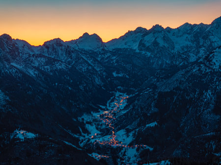 Aerial drone view of the Pescul, human settlement, in Dolomites, Italy, illuminated in the eveningの写真素材