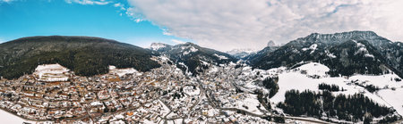 Aerial drone panorama of the Ortisei town covered in snow, within the Dolomites, in northern Italyの写真素材