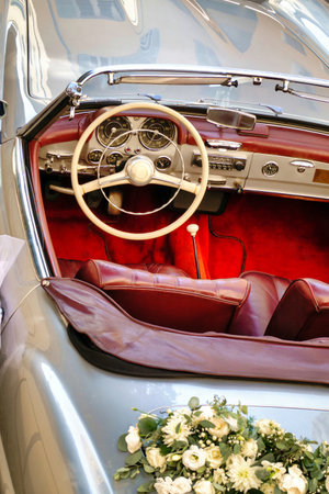 Old vintage convertible car at a wedding church in Antibes, France