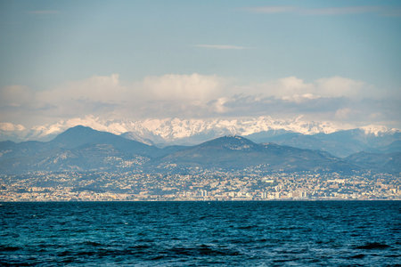 Alps mountains with white snow and clouds, sea in Nice, France,の写真素材
