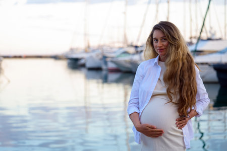 Pregnant woman posing at the port of Golfe Juan, Franceの写真素材