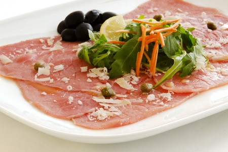 White meat   Carpaccio with Parmesan Cheese in white tableの写真素材