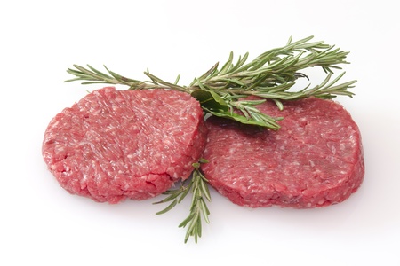 some raw hamburgers isolated on white backgroundの写真素材