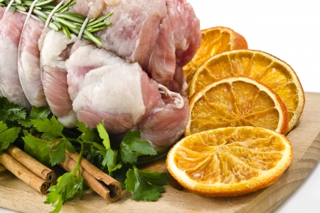 roast of veal with rosemary, orange slices and cinnemons  in white backgroundの写真素材